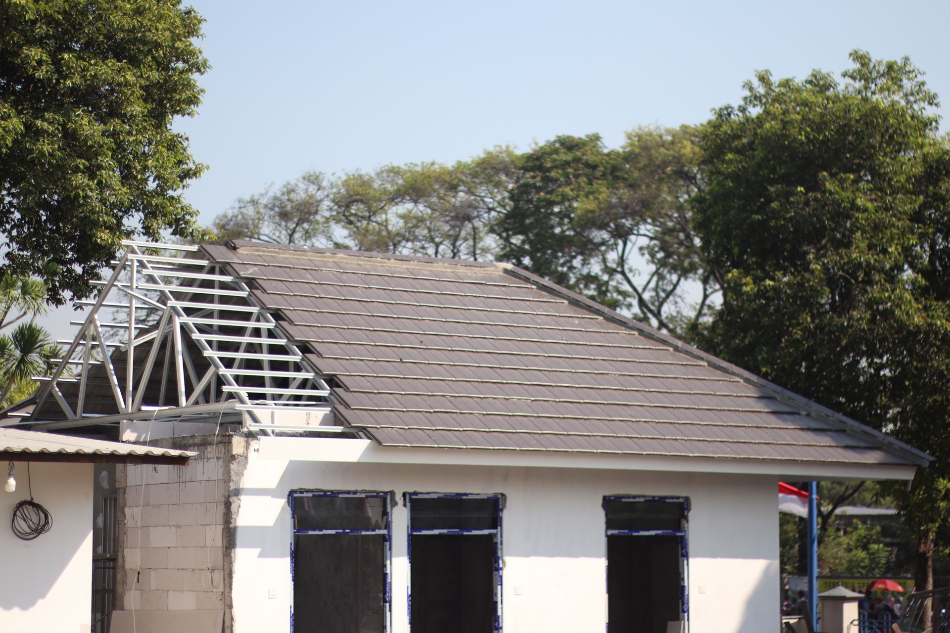 Installing new roof tiles on a house.